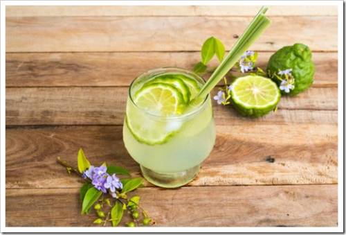 herbal healthy drinks iced kaffir lime cocktail water with bergamot slice local flora of asia arrangement flat lay style on background wooden